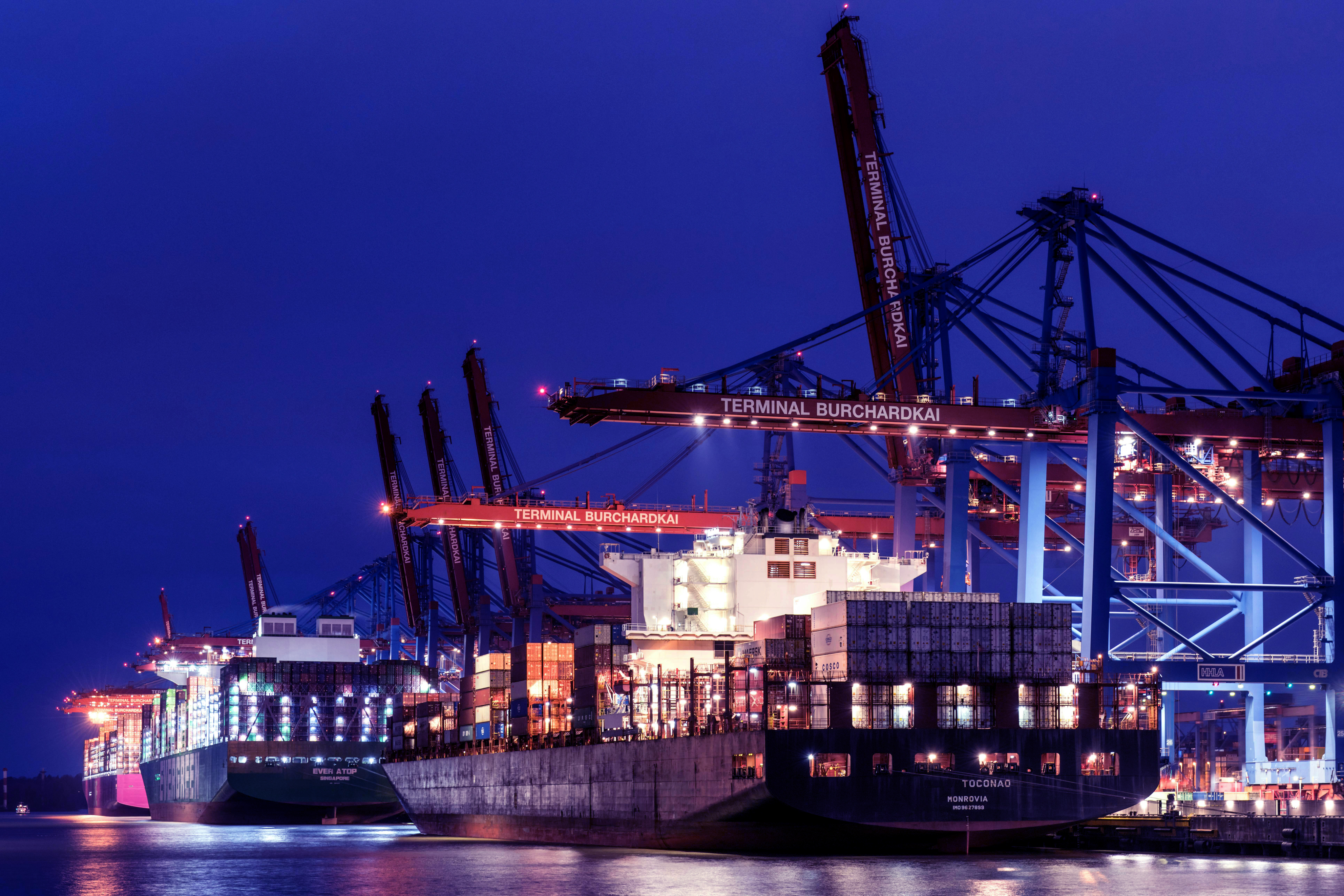 A render of three white cylindrical columns, against a warm creme background
